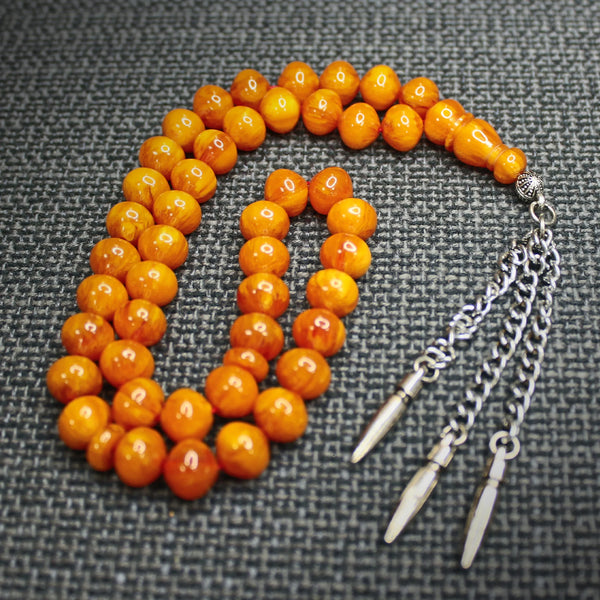 Antique musky sandalous rosary in a distinctive honey color, a small bead woven with durable propylene thread and a tassel made of a mixture of antimony and metal.